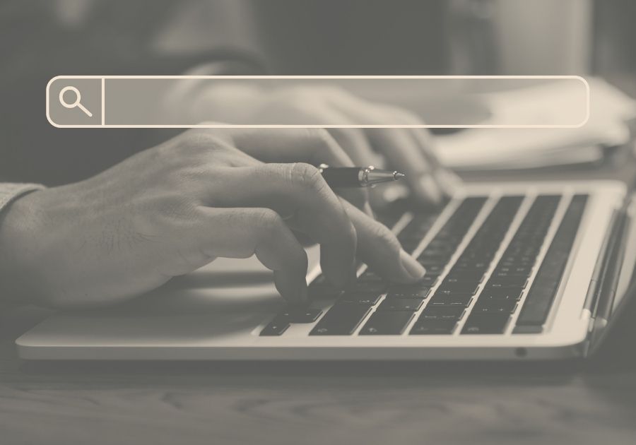 hands typing into search bar of a compute